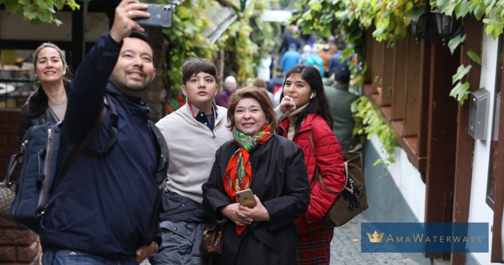 family taking selfie during christmas market