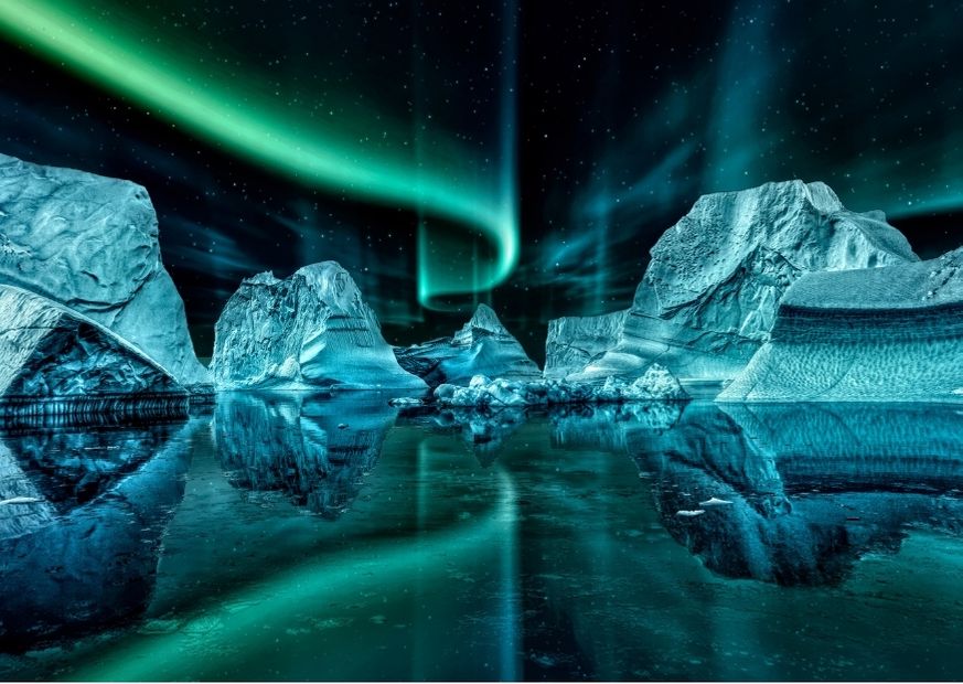 northern lights of greenland by floating iceberg